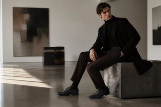 Man wearing the exact Marco Di Milano black pirarucu whole-cut oxford in a modern gallery setting
