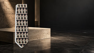Dolce and Gabbana patterned silk tie in a modern stone editorial setting