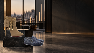 Cesare Paciotti boot and Mauri sneakers displayed in a modern Milan showroom