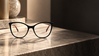 Gucci GG1007O black eyeglasses on a modern Milan dressing table