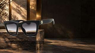 Gucci GG1714S sunglasses displayed on a travertine plinth in a modern Italian interior