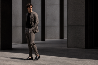 Man wearing the exact black Mezlan Milani leather loafer in modern Italian architecture