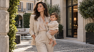 Mother holding a child in a contemporary Milan courtyard.