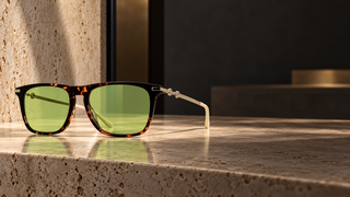 Gucci GG0915SA tortoiseshell sunglasses on a modern optician’s stone counter