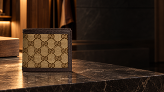 Gucci GG canvas bifold wallet in a modern leather-goods atelier
