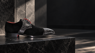 Fennix Landon black suede and exotic leather derby on a dark stone platform