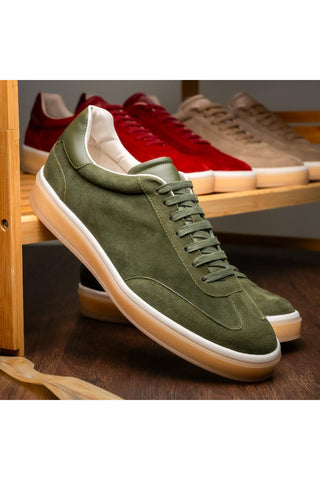 Zelli Italia Gotti olive suede and leather lace-up sneaker with a white rubber sole on a wooden display shelf.