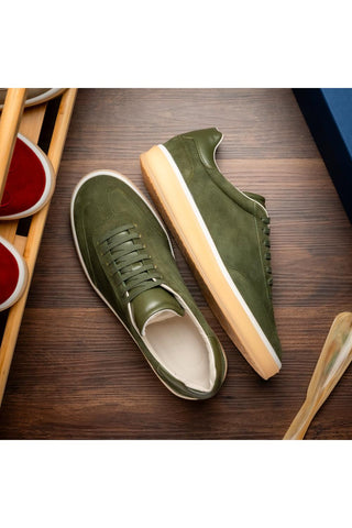 Zelli Italia Gotti olive suede and leather sneakers with a white rubber sole on a wooden surface.