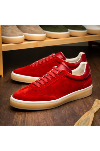 Zelli Italia Gotti red suede and leather lace-up sneakers with a white midsole and rubber outsole on a wooden surface.