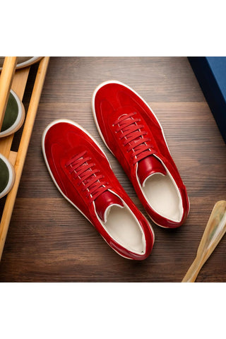 Zelli Italia Gotti red suede and leather lace-up sneakers with a white rubber sole on a wooden surface.