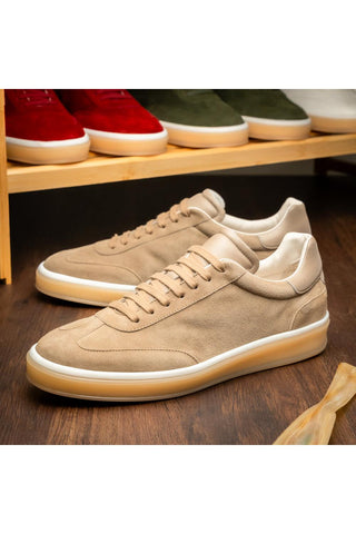 Zelli Italia Gotti taupe suede and leather sneakers with a white rubber sole on a wooden surface.