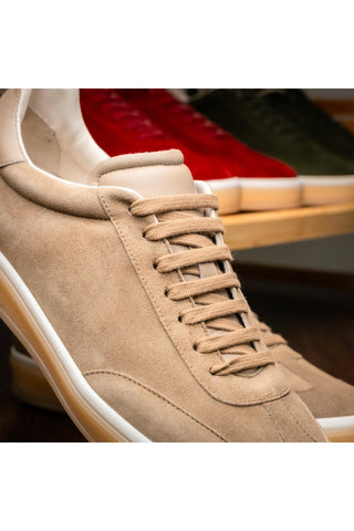 Taupe suede and leather lace-up sneaker with a white midsole and gum rubber outsole.