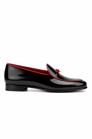 Black patent leather Ambrogio Venezia loafer with red trim and bow tassel.