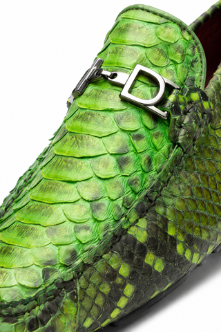 Green python skin loafer featuring a signature silver horse-bit detail and hand-finished artisanal texture.