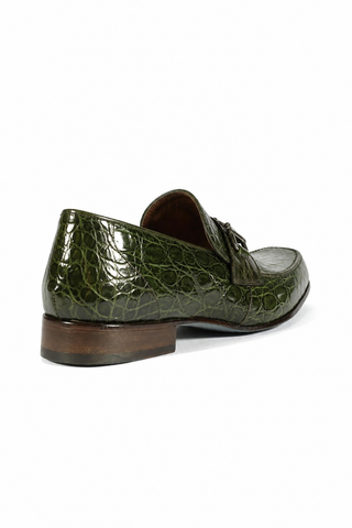 Green caiman crocodile leather loafer with silver horsebit detail and brown leather sole, side view.