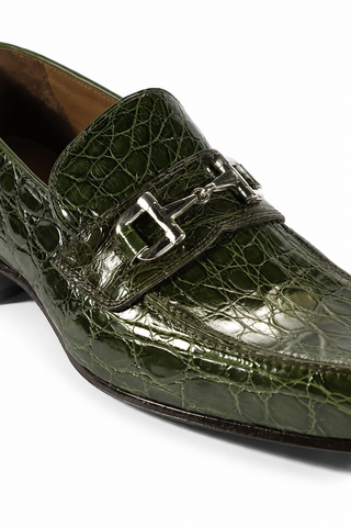 Green caiman crocodile leather loafer with a polished silver horsebit detail and leather sole.