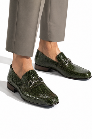 Green caiman crocodile leather loafers with a silver horsebit detail and leather sole.