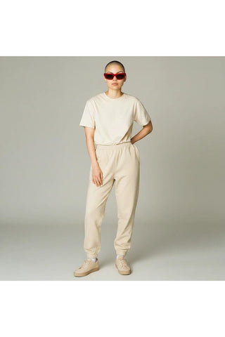Dellamoda model wearing red cat eye Off White MIRAMAR sunglasses with a beige t-shirt and matching sweatpants.